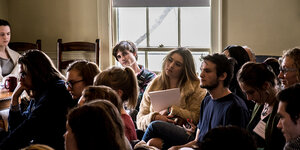 students in audience listening to a reading