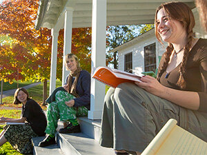 students on a porch with a book