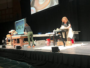 Artist making pottery onstage