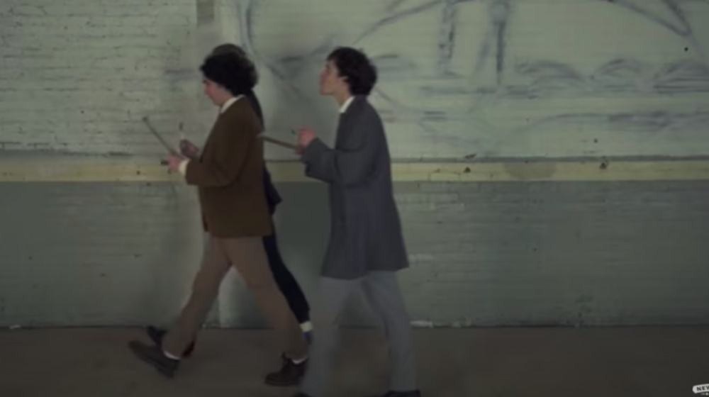 Photo of three men in suits walking