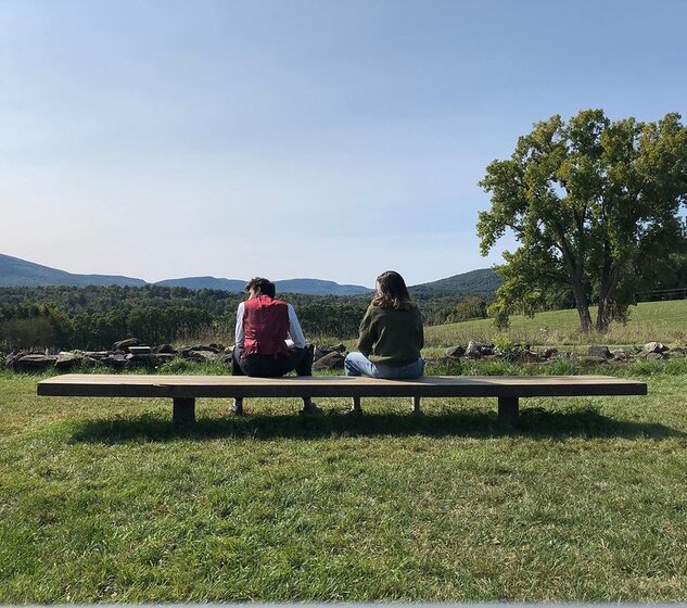 Image of two students on bench