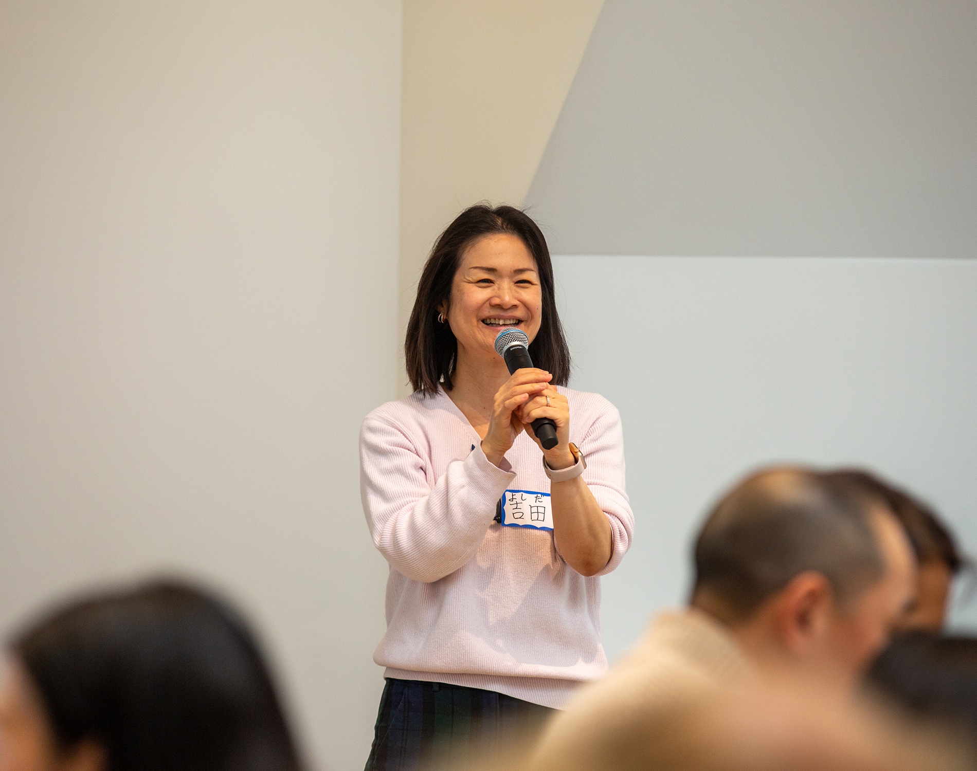 Ikuko Yoshida, faculty member in Cultural Studies and Languages, before a group with a microphone