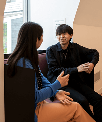 a student speaks 1:1 with a faculty member