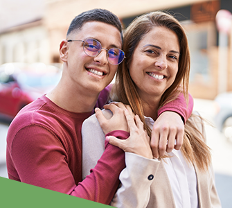 a college aged son hugs his mother