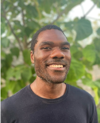 picture of a man smiling in front of a tree