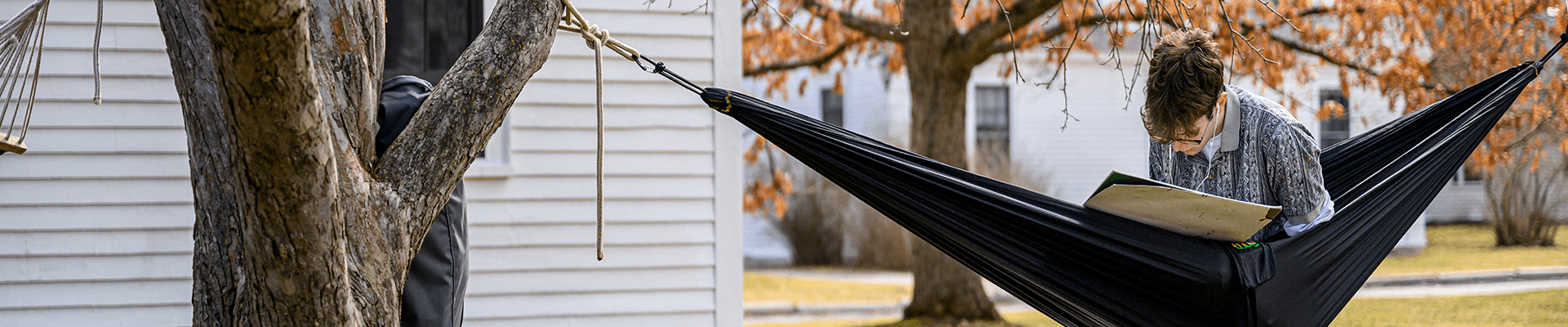 a student works on a project while sitting in a hammock