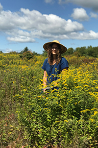 Emily Tareila standing in a field of flowers
