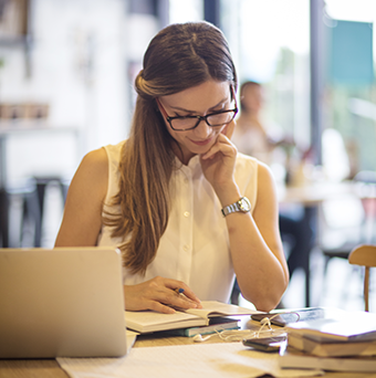 a woman reads and prepares for writing
