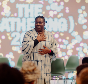 photo of a woman giving a presentation in front of a colorful background