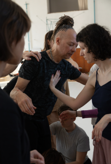 picture of a man instructing a woman in a group