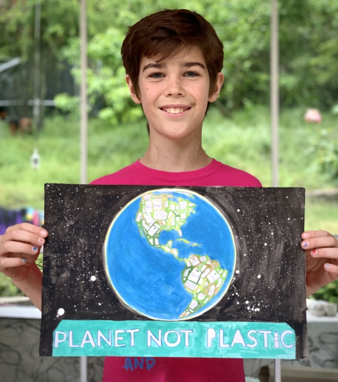 Photo of student holding earth day poster