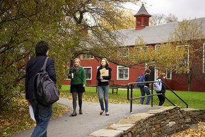 students walking in front of the barn in fall