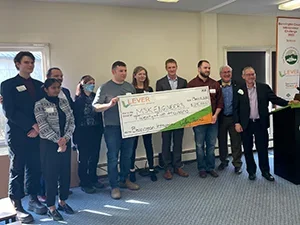 Image of people holding giant check
