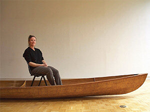 Photo of artist Marie Lorenz sitting in boat