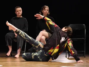 two dancers on stage, two students observe