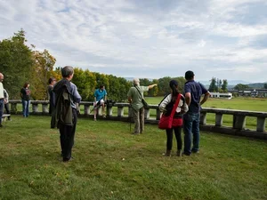 group of people led by kerry woods viewing plants in a field