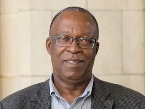 A man wearing a suit and glasses 