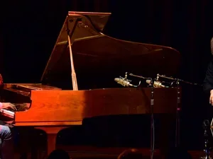 Shipp and Bisio on stage during a performance 