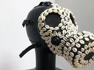 a black sculpture encrusted with white shells