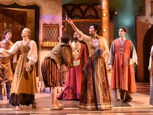 a group of actors in elizabethan costume on stage 