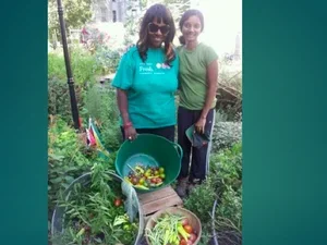 two women standing in a garden