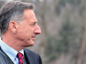 side profile of the head of a man (Peter Shumlin) in a suit with blurred grey background