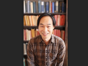 headshot of Tung-Hui Hu in front of a bookcase