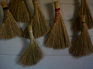 brooms hung on a wall