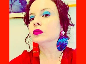 Dorothea Lasky wearing cool funky earrings and red blazer 