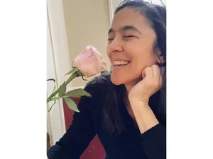 Joyelle McSweeney smelling a rose