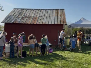 People assemble outside Frost House Museum barn