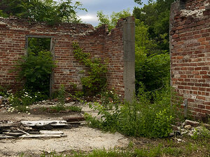 brick courtyard in abandoned ruin with dancer performer lying on the dusty ground