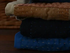 a stack of mended clothes on a table