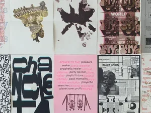 brightly printed posters from the bring it home show on a table