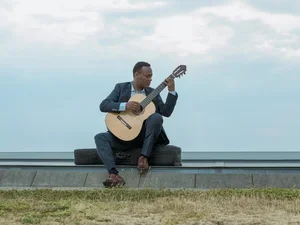 Raphaël Feuillâtre outside with a guitar