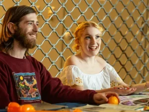 two students welcome admitted students at a tabling event