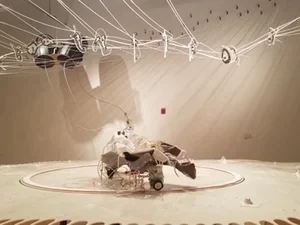 white stage with sculpture by umphlett at center