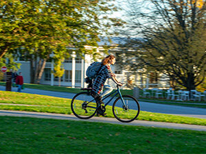 student biking on campus