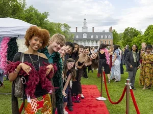 a group of happy seniors smile for the camera while on the red carpet