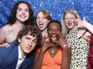 Five students do silly poses in the photobooth