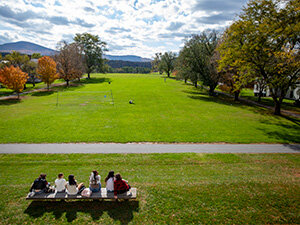 group of students sitting at a picnic table on Bennington campus