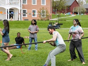 International students playing tug of war on the Lawn