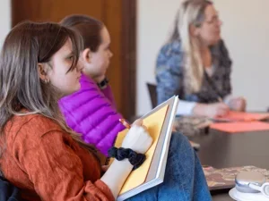students listen in class and take notes on paper