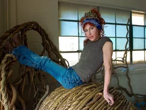 Laura Spector atop a Sculpture