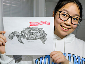 Photo of girl holding turtle poster
