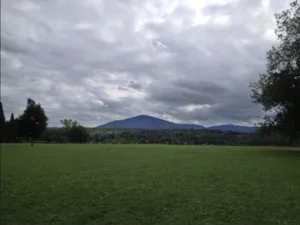 end of the world, green grass, cloudy sky
