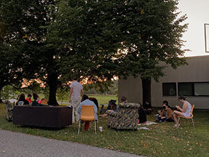 Image of students sitting outdoors on furniture