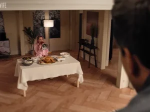 Image of small woman sitting at table