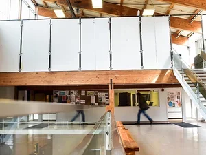 a bright, open, interior space with white walls and 3 levels