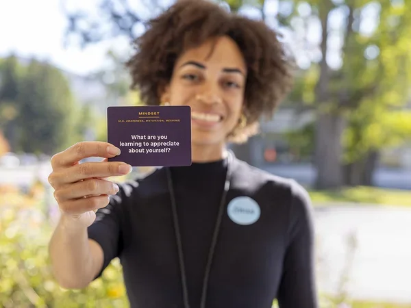 Dānia Clarke holding conversation card